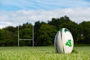 Rugby ball on a grassy pitch in Galway, Ireland during summer.